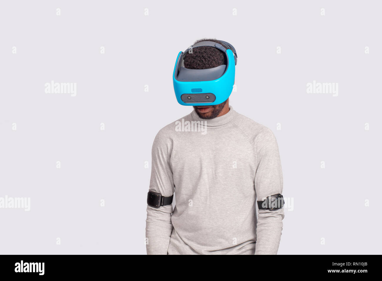 Virtual Reality headset on a black male with video game controllers ...