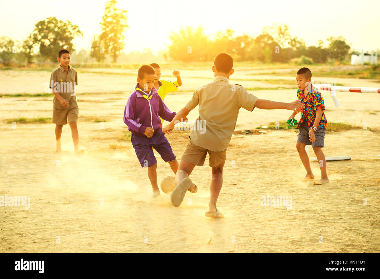 group of kids having fun playing soccer football for exercise and