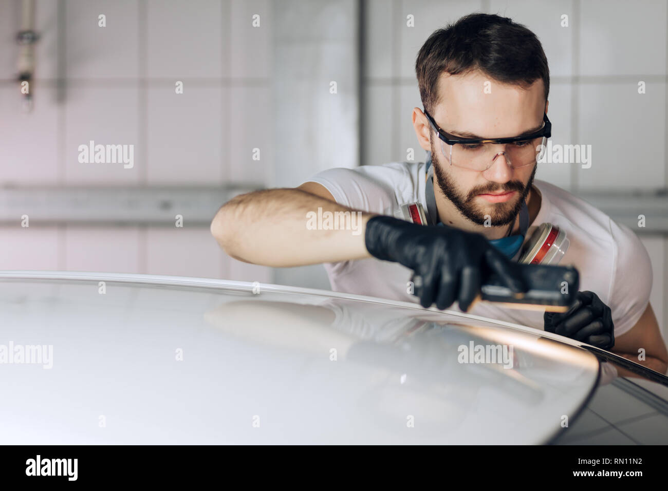 measurements of painting thickness. mechanic measuring the paint