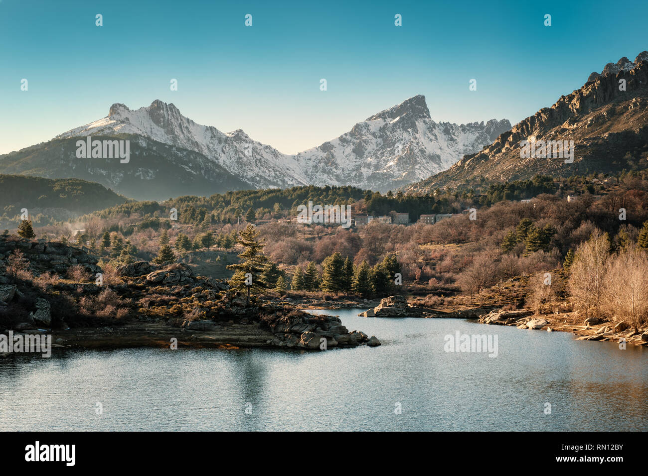 River Golo with the village of Albertacce in the distance and snow capped Paglia Orba mountain in central Corsica Stock Photo
