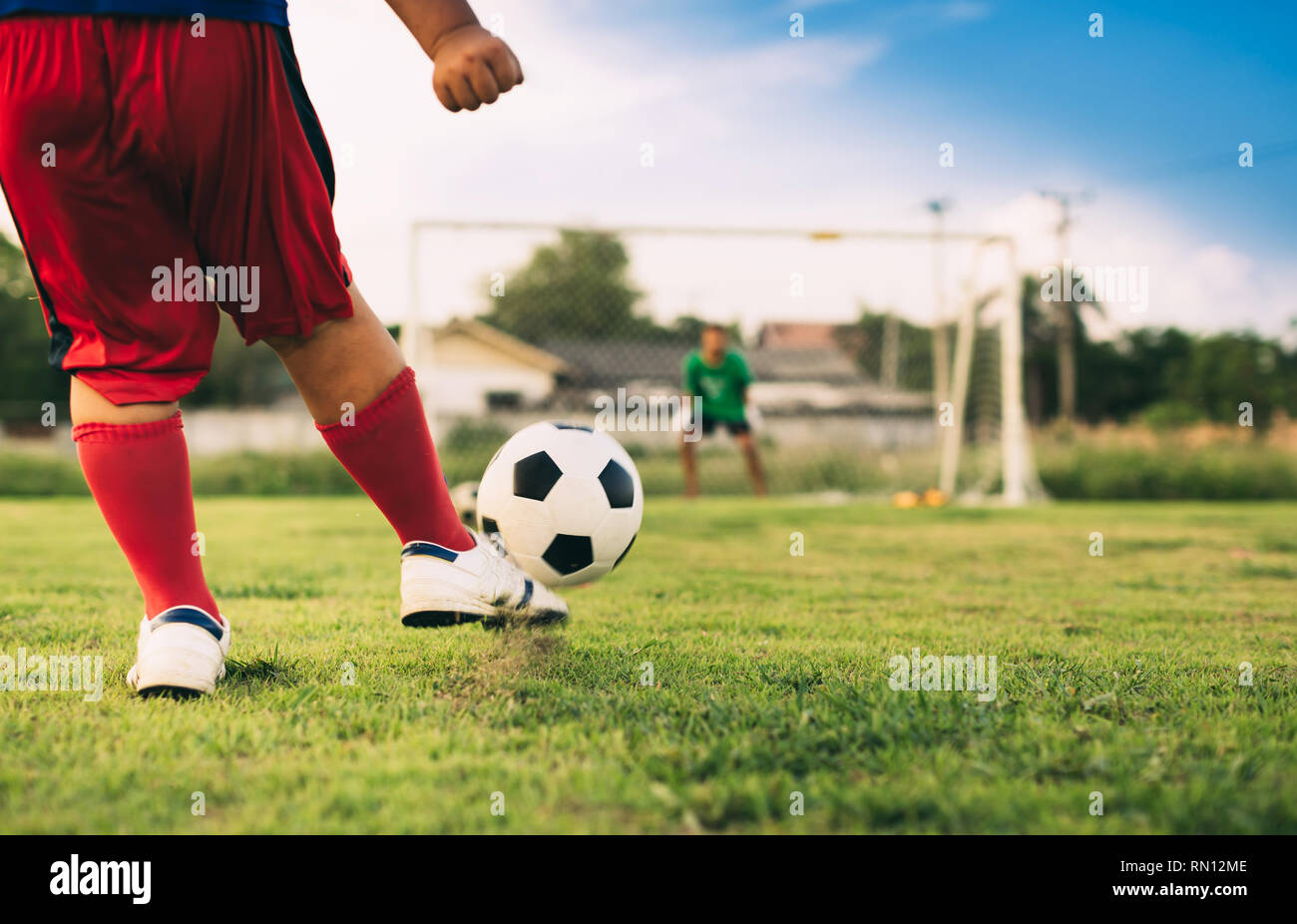 action sport outdoors of a group of kids having fun playing soccer ...