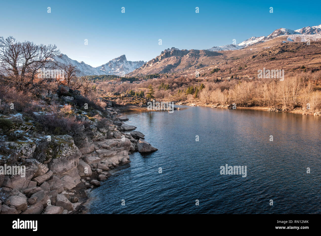 River Golo with the village of Albertacce in the distance and snow capped Paglia Orba mountain in central Corsica Stock Photo