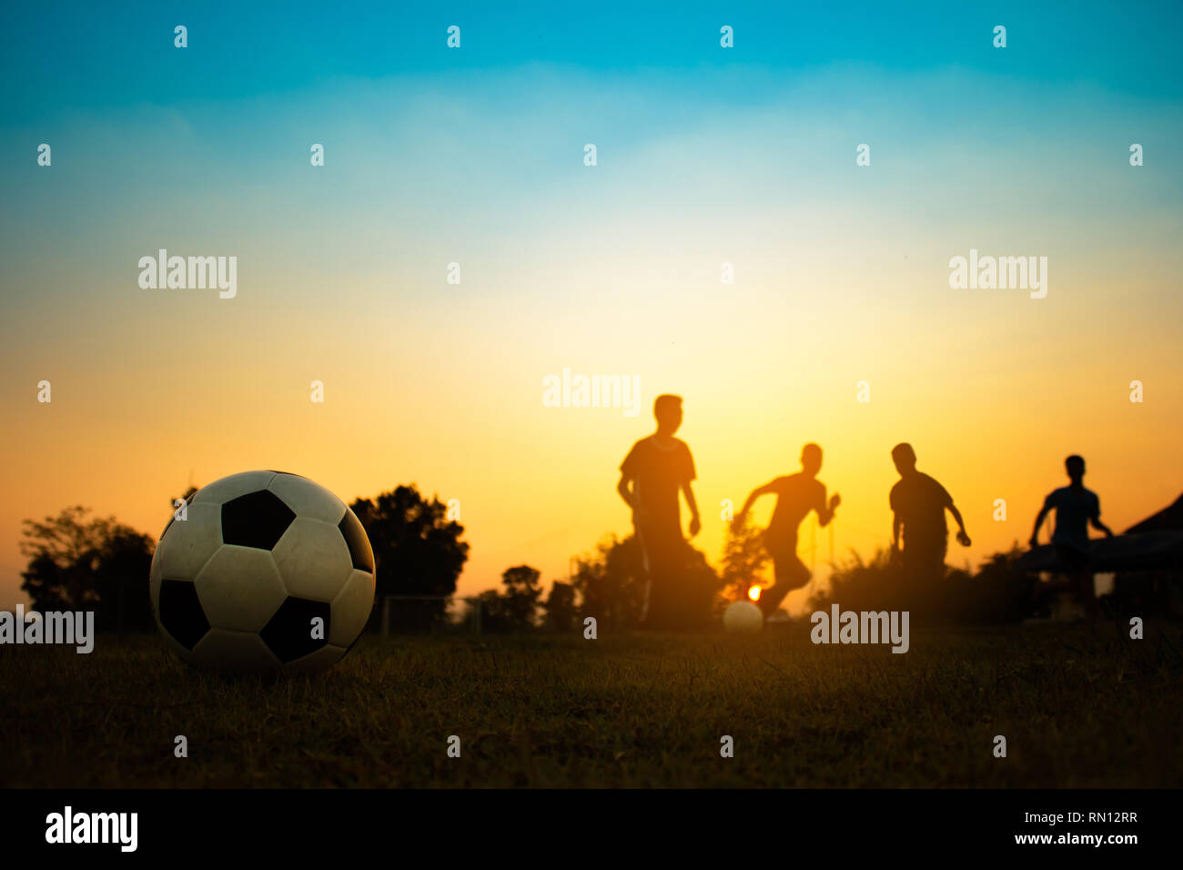 action sport outdoors of a group of kids having fun playing soccer