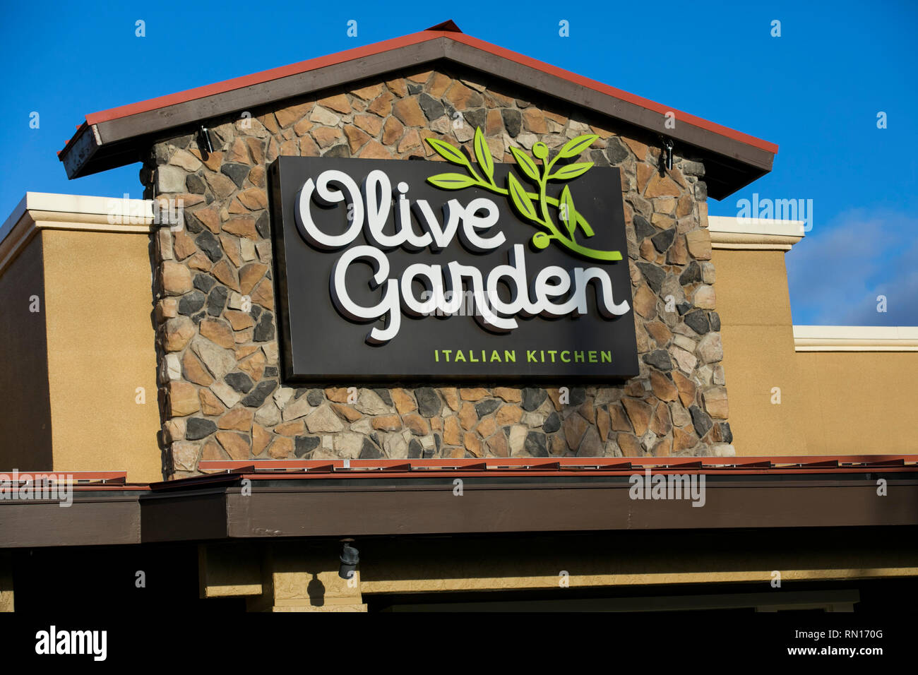 A Logo Sign Outside Of A Olive Garden Restaurant Location In
