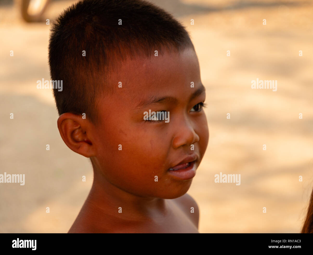 Portrait of a cute, happy,smiling, young, local,   primary school age Cambodian child  Kampong Tralach, Oudong, Cambodia, Asia Stock Photo