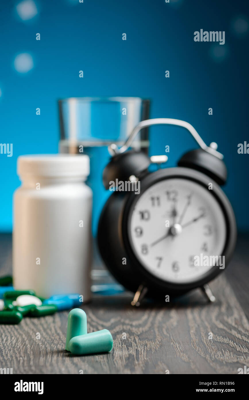 Earplugs, alarm clock and pills Stock Photo Alamy