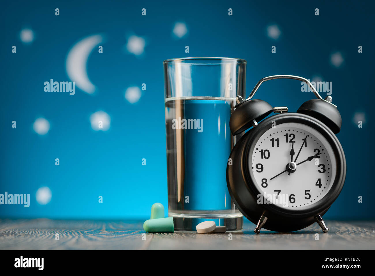 Earplugs, pills and alarm clock Stock Photo Alamy