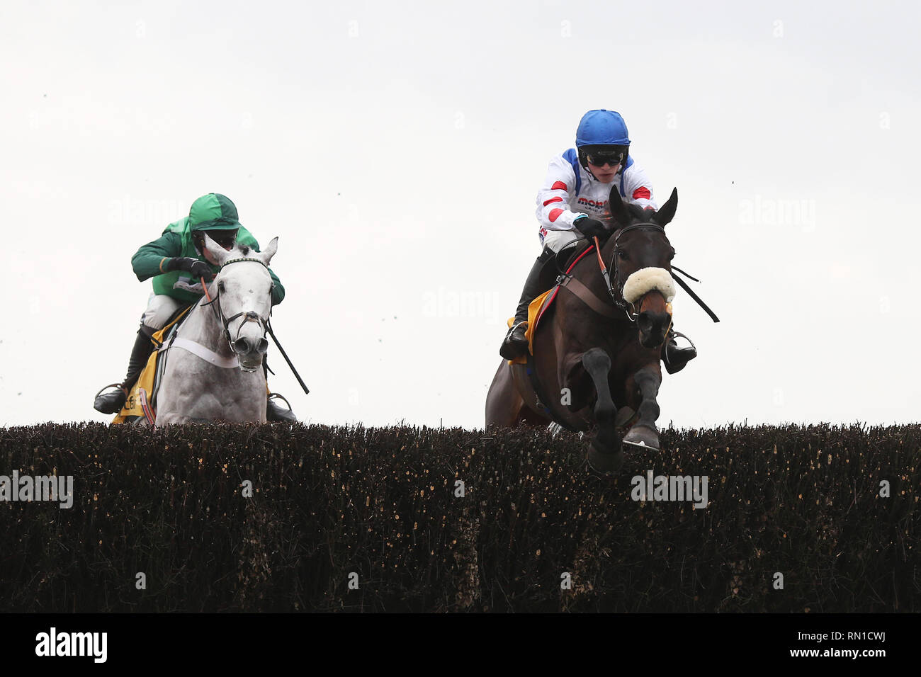 Clan Des Obeaux and Harry Cobden (right) lead Terrefort and Nico de Boinville over the last fence before winning The Betfair Denman Steeple Chase Race run at Ascot Racecourse. Stock Photo