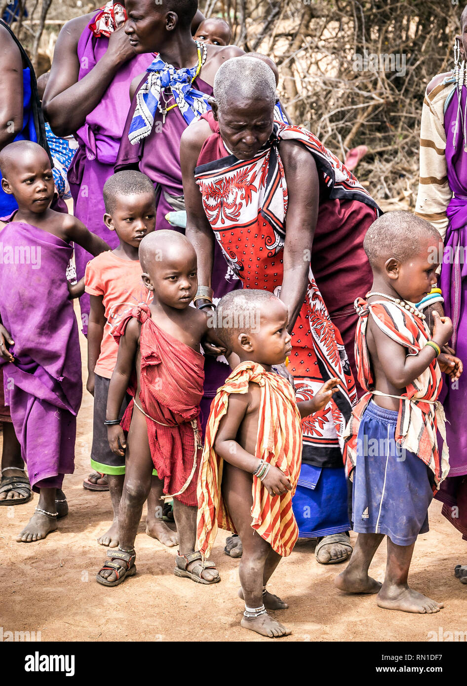 MASAI VILLAGE, KENYA - OCTOBER 11, 2018: Unindentified african people wearing traditional clothes in Masai tribe, Kenya Stock Photo