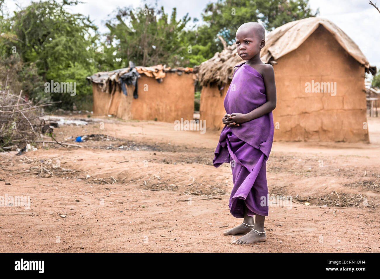 MASAI VILLAGE, KENYA - OCTOBER 11, 2018: Unindentified african child wearing traditional clothes in Masai tribe, Kenya Stock Photo