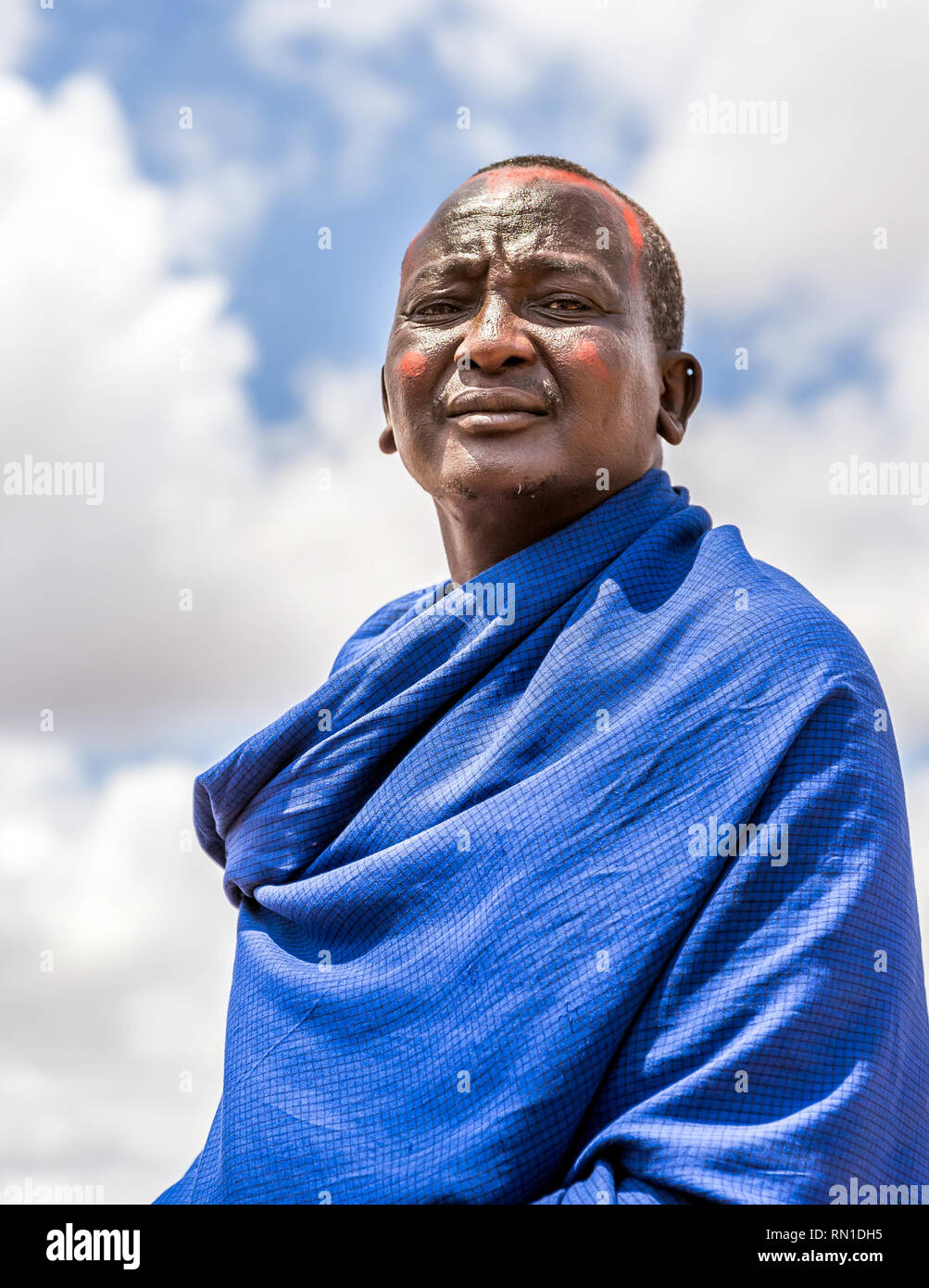 MASAI VILLAGE, KENYA - OCTOBER 11, 2018: Unindentified african man wearing traditional clothes in Masai tribe, Kenya Stock Photo