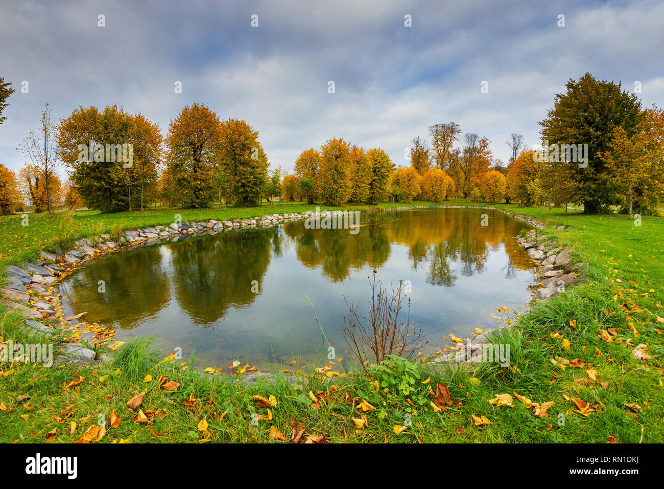 Artificial lake waterscape surrounded by the fall season's scenery in Barockparken (Barok park), Upplands Vasby, STHLM, Sweden Stock Photo