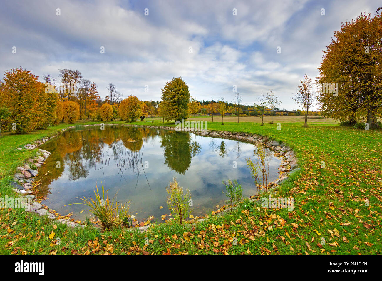 Artificial landscaping waterscape surrounded by the fall season's scenery in Barockparken (Barock park), Upplands Vasby, STHLM, Sweden Stock Photo