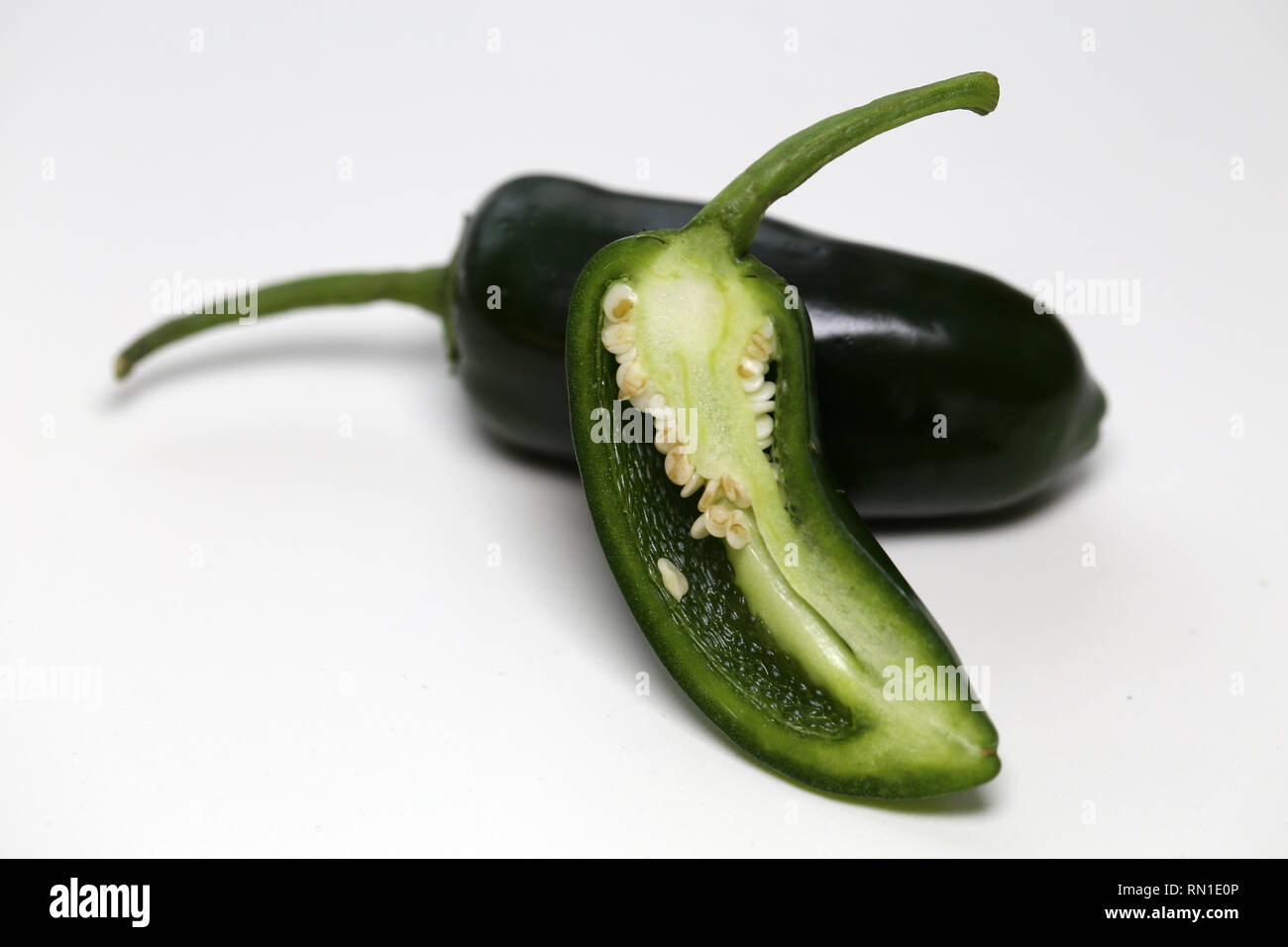 Beautiful, fresh green spicy jalapeno pepper photographed on a white