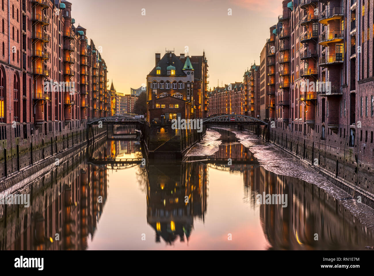 The historic Speicherstadt with the Wasserschloss in Hamburg, Germany, after sunset Stock Photo
