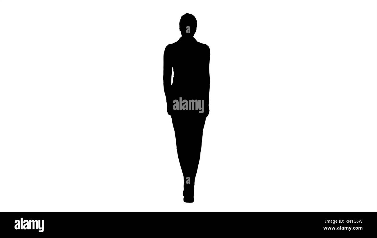 Silhouette Confident young business woman walking Stock Photo - Alamy