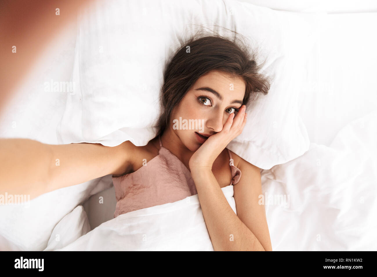 Image from top of pretty woman 20s with dark hair taking selfie photo