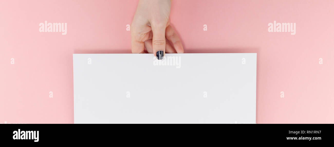Creative flat lay top view of woman hands black manicure with empty A4 ...