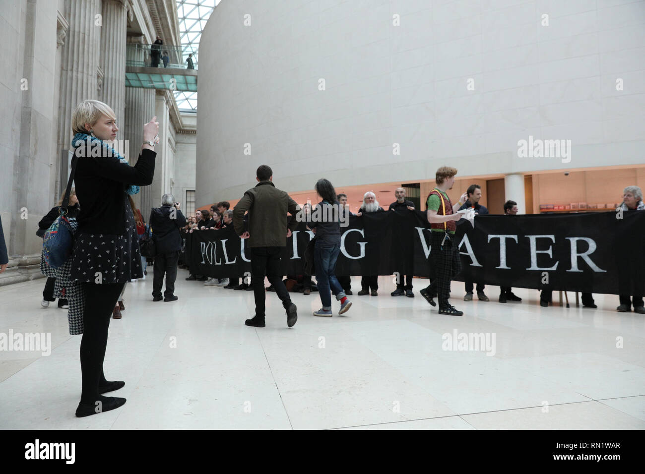 British Museum, London, UK, 16th Feb 2019. 'BP or Not  BP - No War No Warming' protest. Hundreds of protesters from 'BP or Not BP' have formed human chains with messages and later stage a sit in to protest against BP sponsoring the exhibition ' I am Ashurbanipal' at the museum. Protesters rally both within the British Museum Great Hall and outside the exhibition entrance. Stock Photo