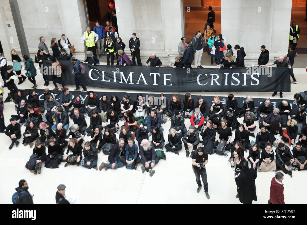 British Museum, London, UK, 16th Feb 2019. 'BP or Not  BP - No War No Warming' protest. Hundreds of protesters from 'BP or Not BP' have formed human chains with messages and later stage a sit in to protest against BP sponsoring the exhibition ' I am Ashurbanipal' at the museum. Protesters rally both within the British Museum Great Hall and outside the exhibition entrance. Stock Photo