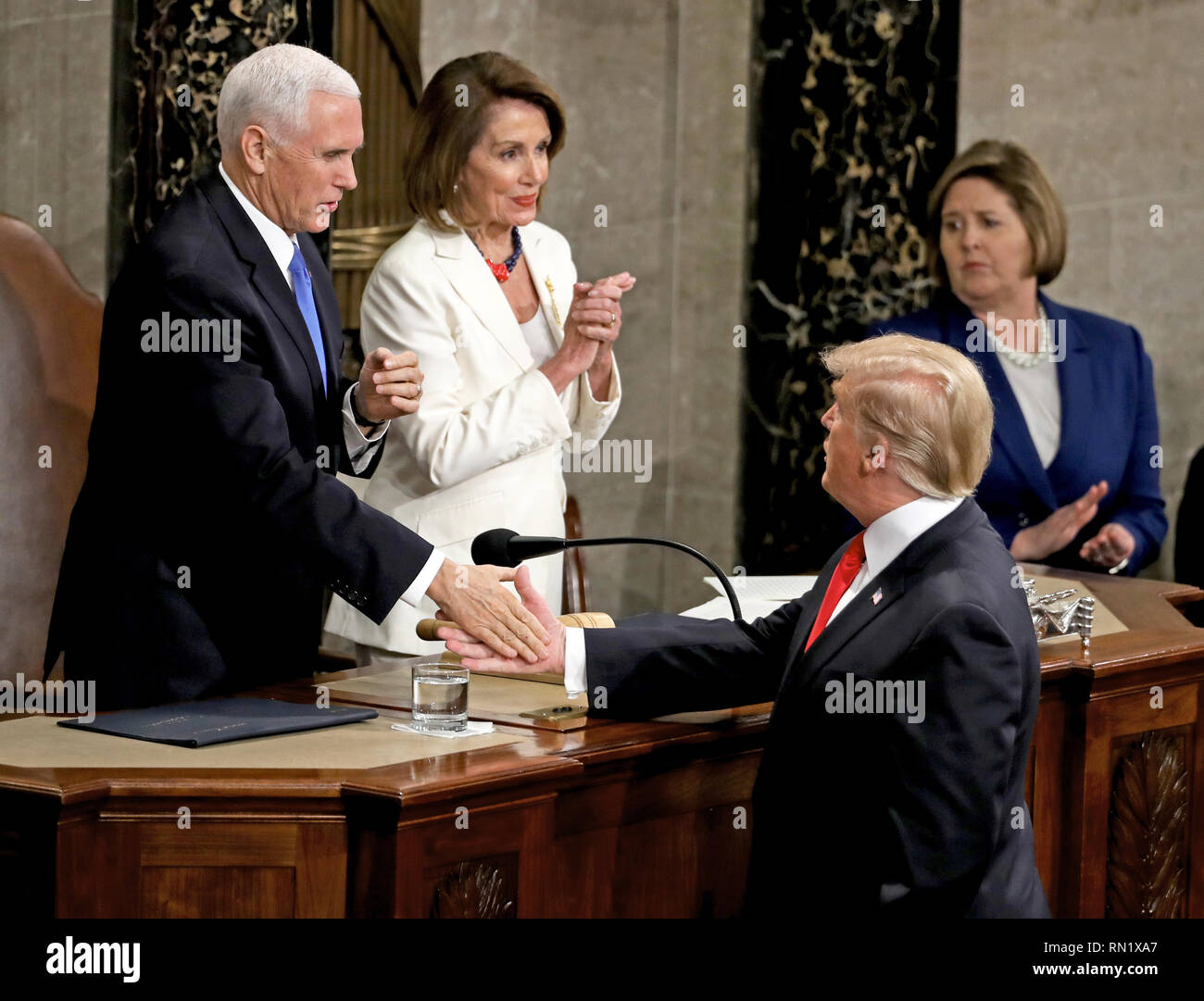 Washington DC, USA. 5th February 2019. United States President Donald J. Trump shakes hands with US Vice President Mike Pence after delivering his second annual State of the Union Address to a joint session of the US Congress in the US Capitol in Washington, DC on Tuesday, February 5, 2019. At center is Speaker of the US House of Representatives Nancy Pelosi (Democrat of California). Credit: Alex Edelman/CNP | usage worldwide Credit: dpa picture alliance/Alamy Live News Stock Photo