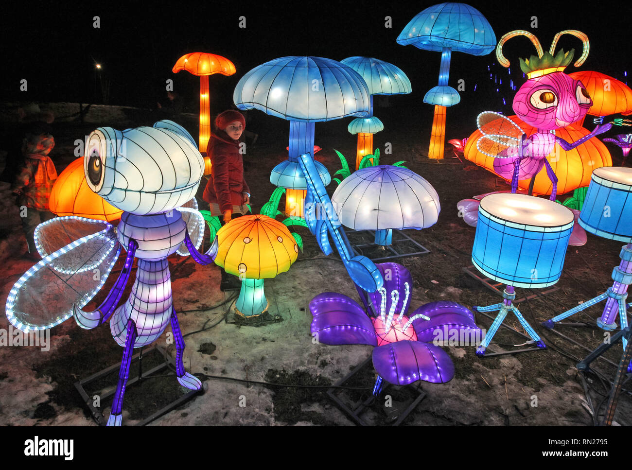 Kiev, Ukraine. 16th Feb 2019. Children seen looking on lanterns installations during 'Giant Chinese lanterns festival' at the Singing Field in Kiev. 15 thousand light bulbs and more than two kilometers of silk are used for 30 giant light installations, each of which symbolizes an ancient folk tale or legend of China. The festival of giant Chinese lanterns is one of the most famous exhibitions in the world, which was held in more than 40 countries,according the organizers. Credit: SOPA Images Limited/Alamy Live News Stock Photo