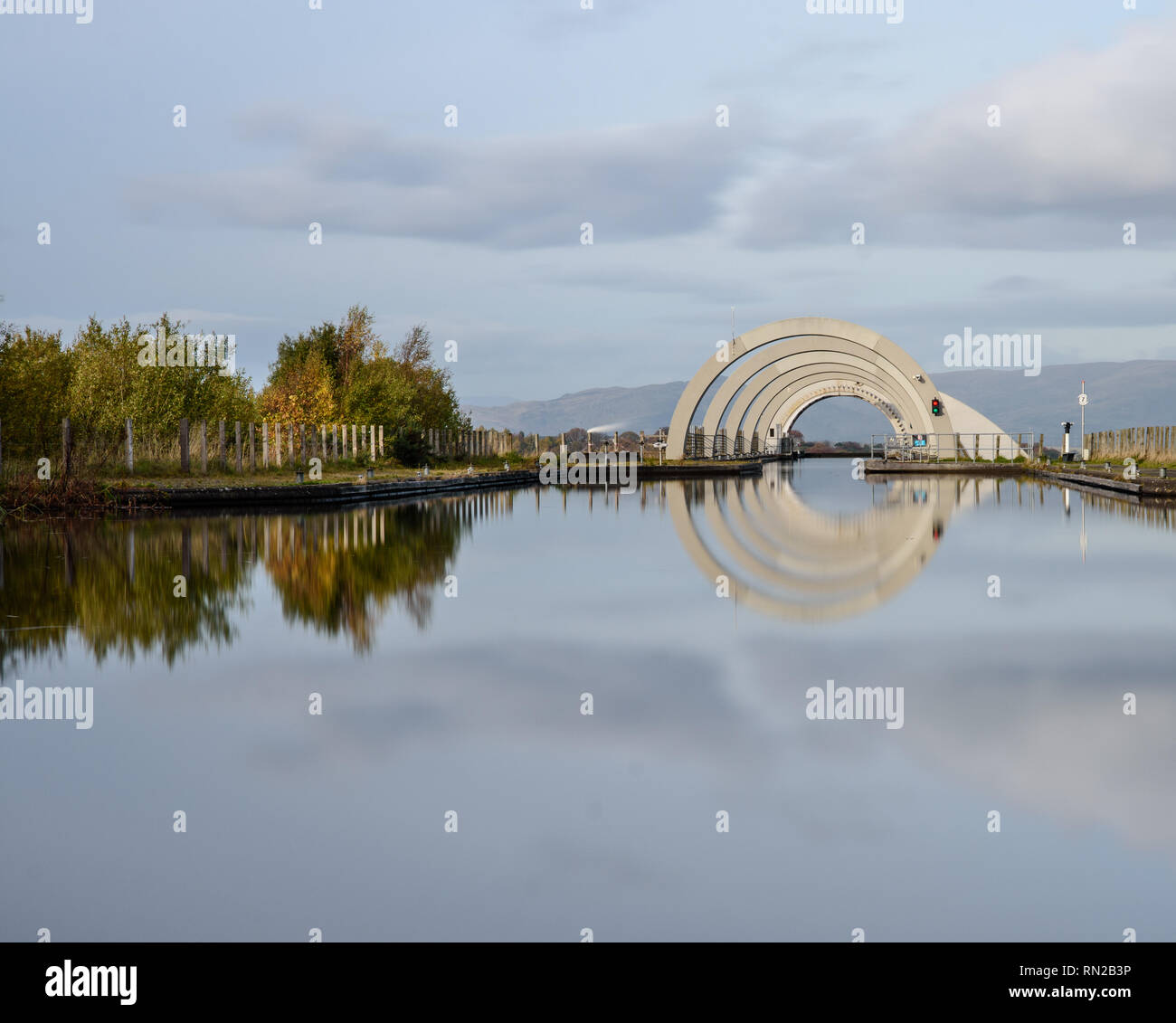 Trees displaying autumn colours are reflected in the waters of the Union Canal above the Falkirk Wheel in Scotland. Stock Photo
