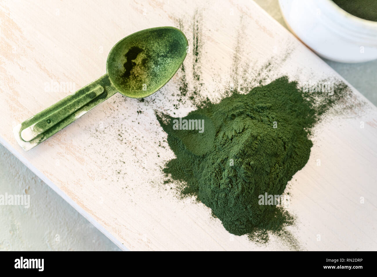 Green Spirulina algae powder, healthy dietary supplement on wooden ...