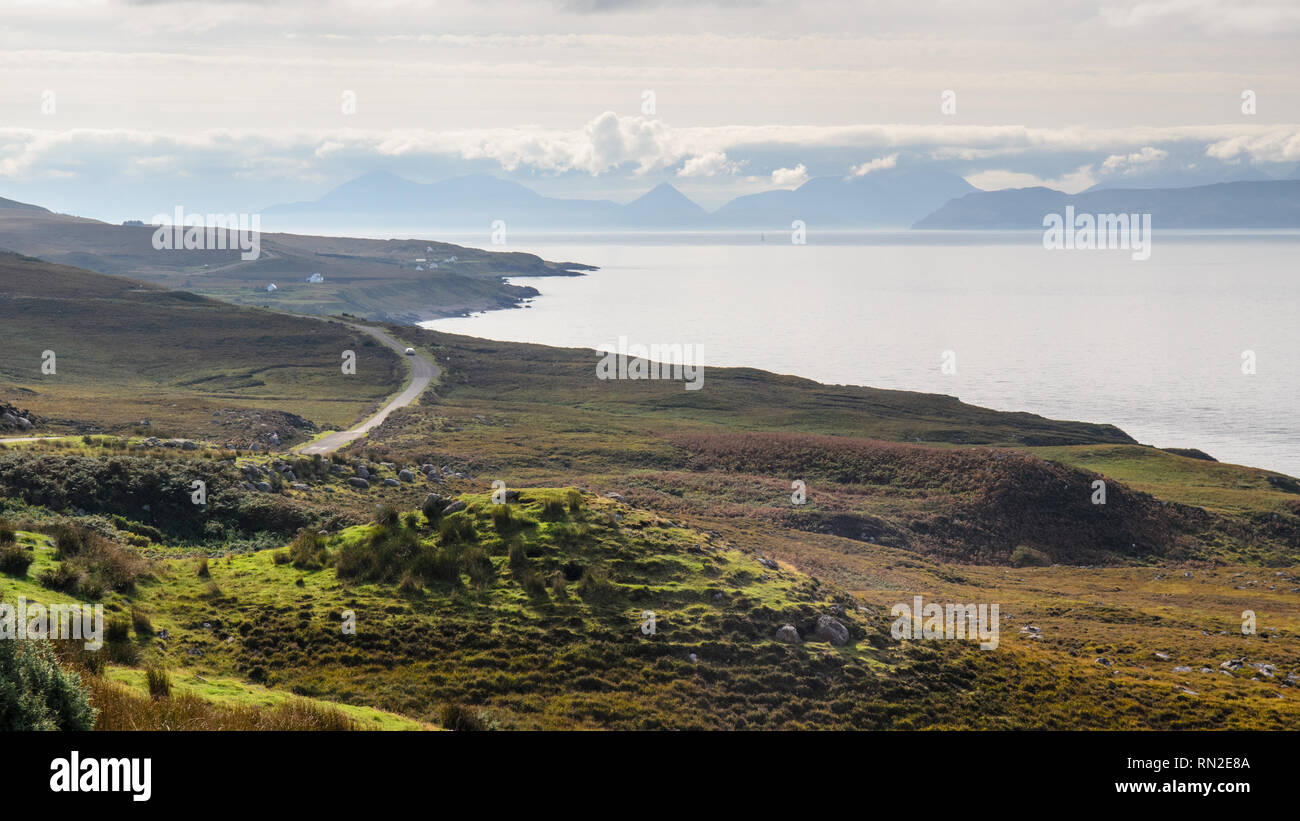 Applecross, Scotland, UK - September 24, 2013: A single car winds along the narrow cliff-top roads of the North Coast 500 route on the Applecross Peni Stock Photo