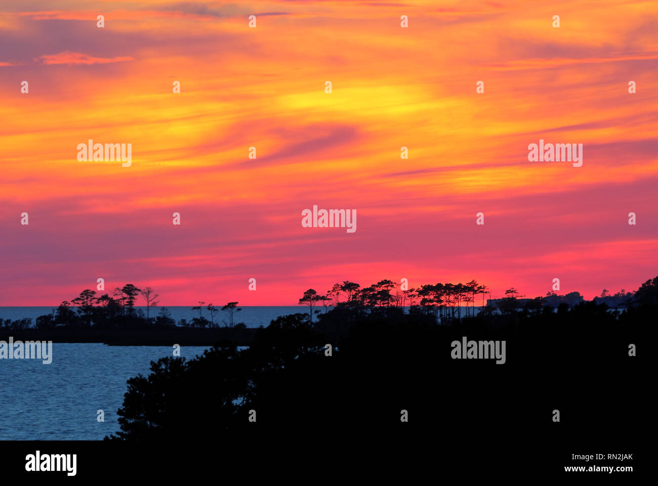 Dramatic, coloful sunset over Albemarle Sound as viewed from Jockeys Ridge State Park in the town of Nags Head on the Outer Banks of North Carolina Stock Photo