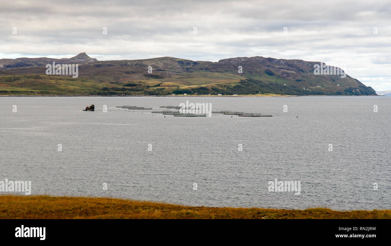 Fish farm cages are anchored in the Sound of Raasay, among the Hebrides Islands of Skye and Raasay in the Atlantic Ocean off the coast of Scotland. Stock Photo