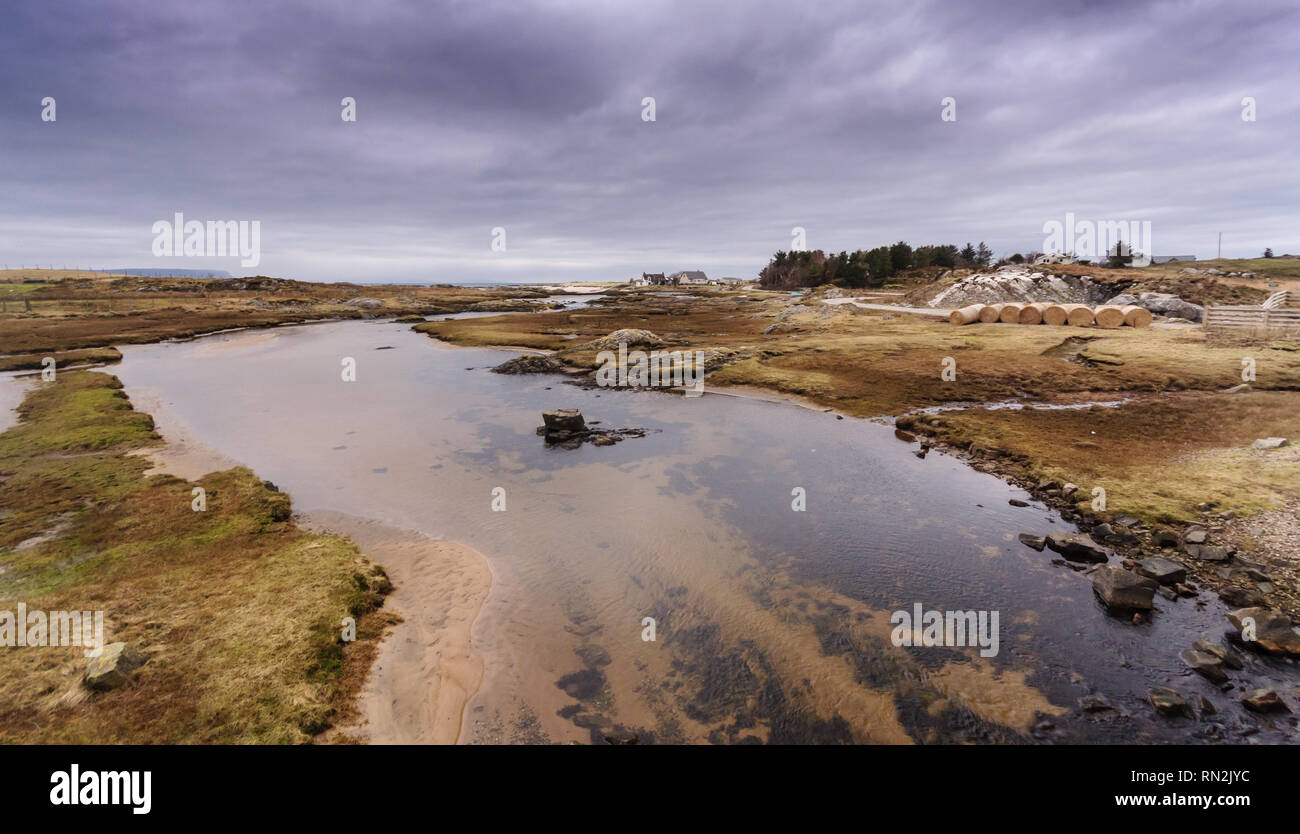 A small river forms an estuary across coastal salt marsh at Arisaig in the West Highlands of Scotland. Stock Photo