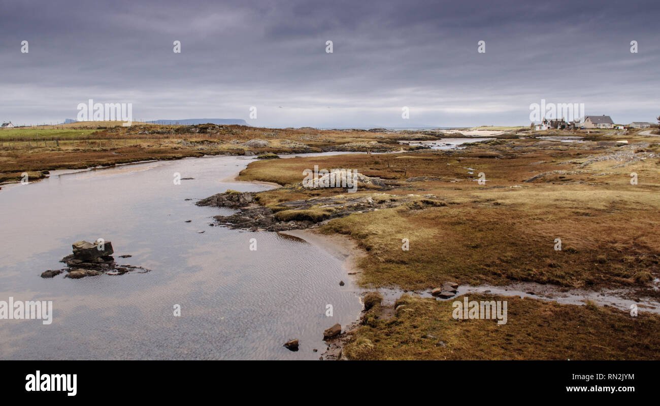 A small river forms an estuary across coastal salt marsh at Arisaig in the West Highlands of Scotland. Stock Photo