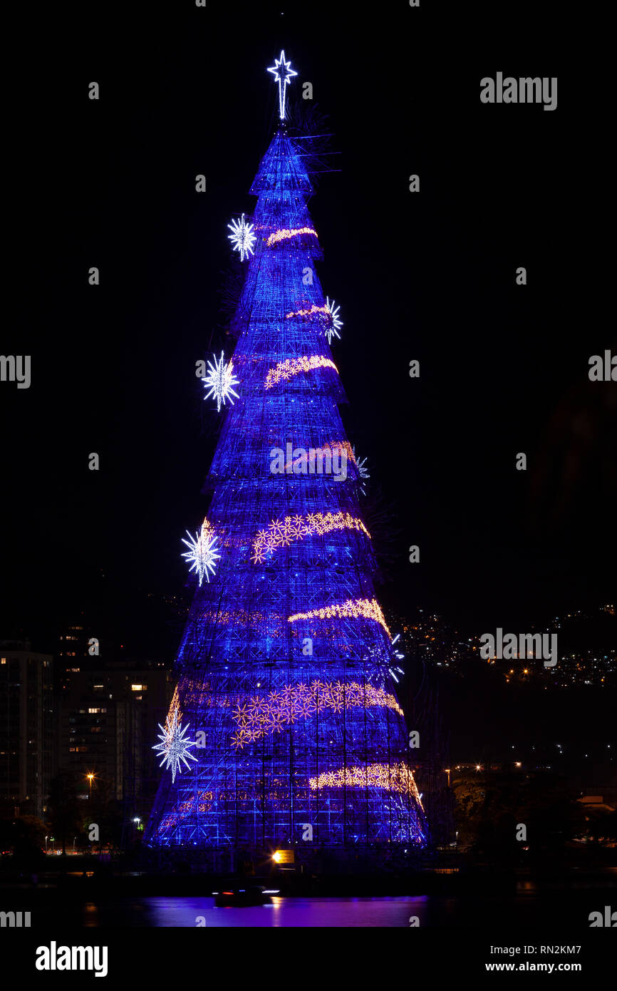 Tallest floating Christmas tree in the world construction with tons of lights changing designs and colours at night in the city lake of Rio de Janeiro Stock Photo