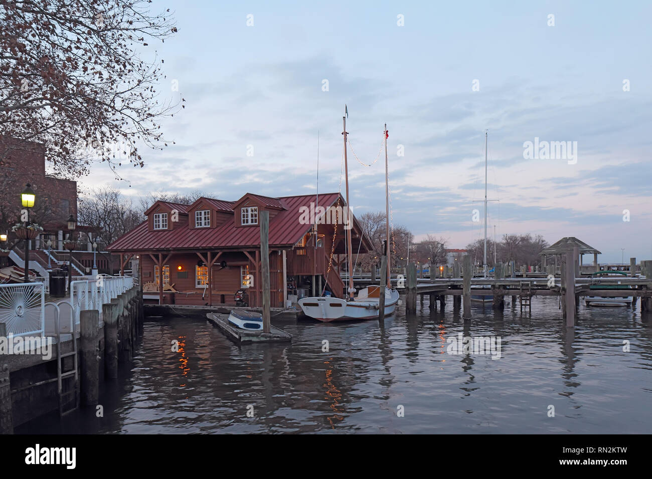 Boats and waterfront of Alexandria, Virginia viewed from the water at sunset Stock Photo