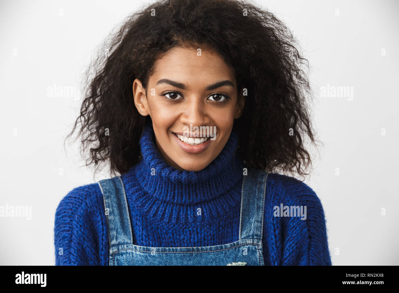 Close up of a pretty young african woman wearing sweater standing ...