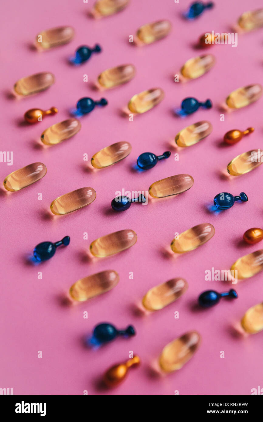 Capsule background with Omega 3, hyaluronic acid and coenzyme. Caring