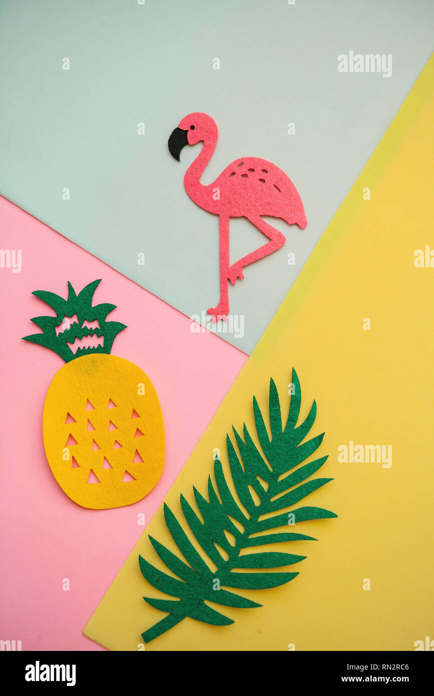 Flamingo, tropical leaf and pineapple on a colored background. Summer background. Stock Photo