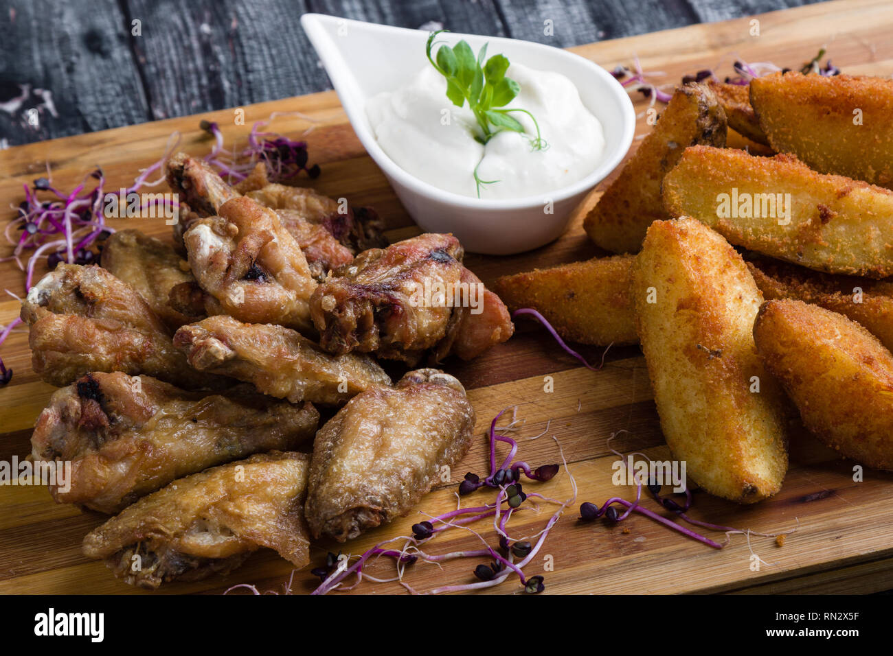 fried chicken wings with potato and dipping sauce Stock Photo Alamy