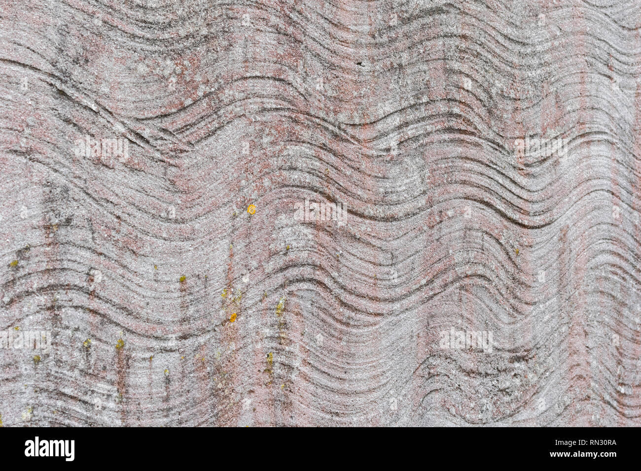 Abstract irregular wavy lines in cement rendered wall with light faded paint. Stock Photo