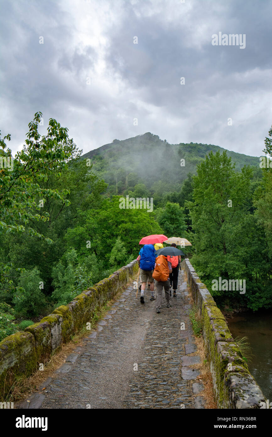 Conques, France - June 2015: a group of pilgrims are crossing a small ...
