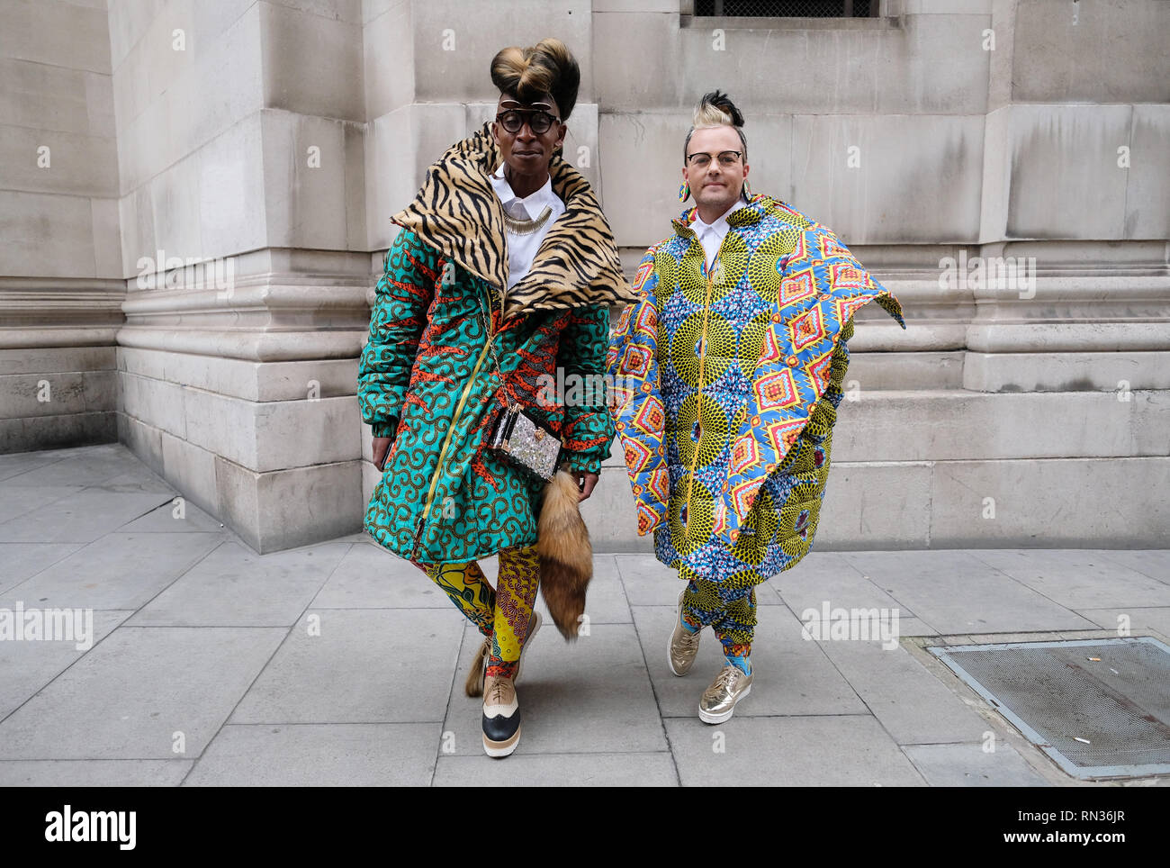 (right to left) Fashion designers Abiah Superstar and Brad Muttitt wear animal print during the Autumn/ Winter 2019 London Fashion Week outside Freemasons' Hall, London. Stock Photo