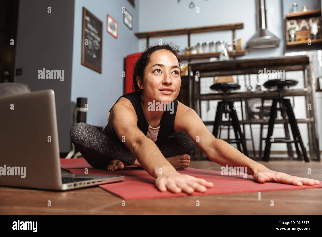 Beautiful Healthy Woman Doing Yoga Exercises While Sitting On A