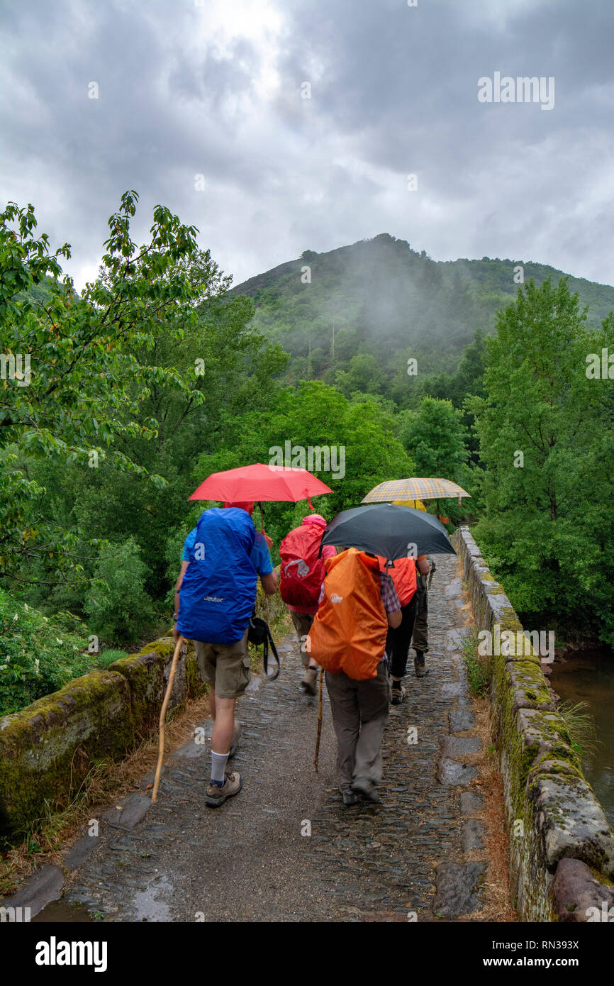 Conques, France - June 2015: a group of pilgrims are crossing a small ...