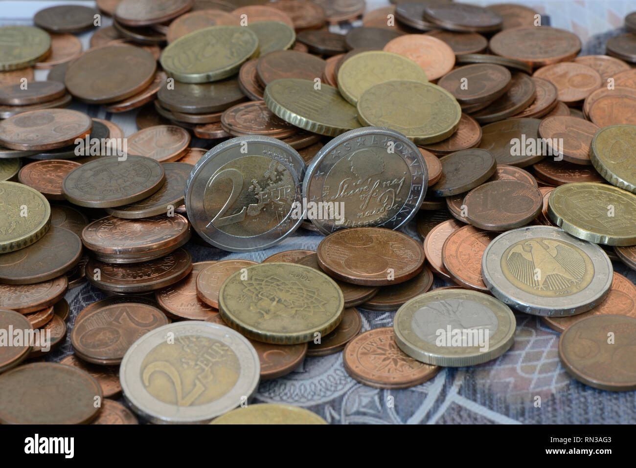 Euro coins and Euro cent coins on an old Austrian thousand-schilling bill Stock Photo
