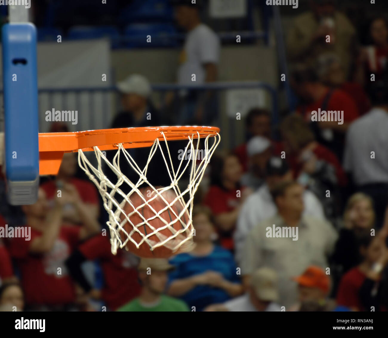 Basketball swooshes through a basketball hoop during a basketball