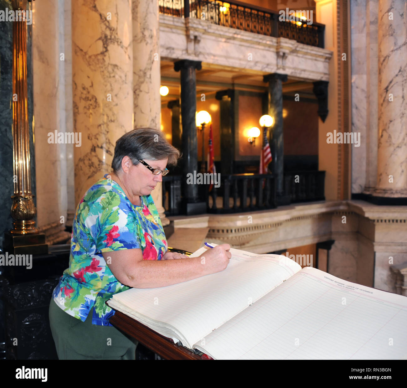 Visitor Signs Guest Book Inside The Capital Building In