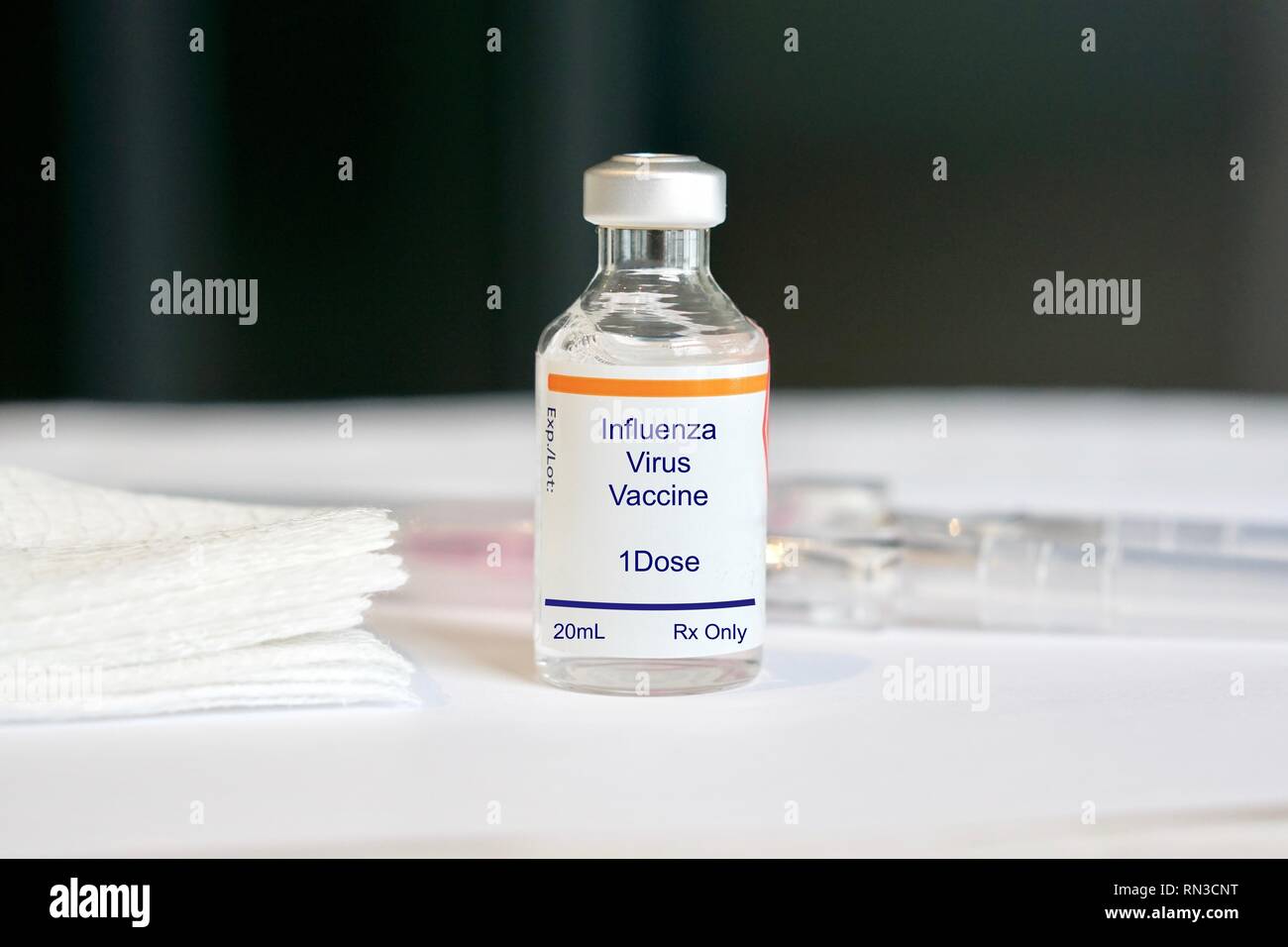 Influenza vaccine in a glass vial in a medical setting Stock Photo