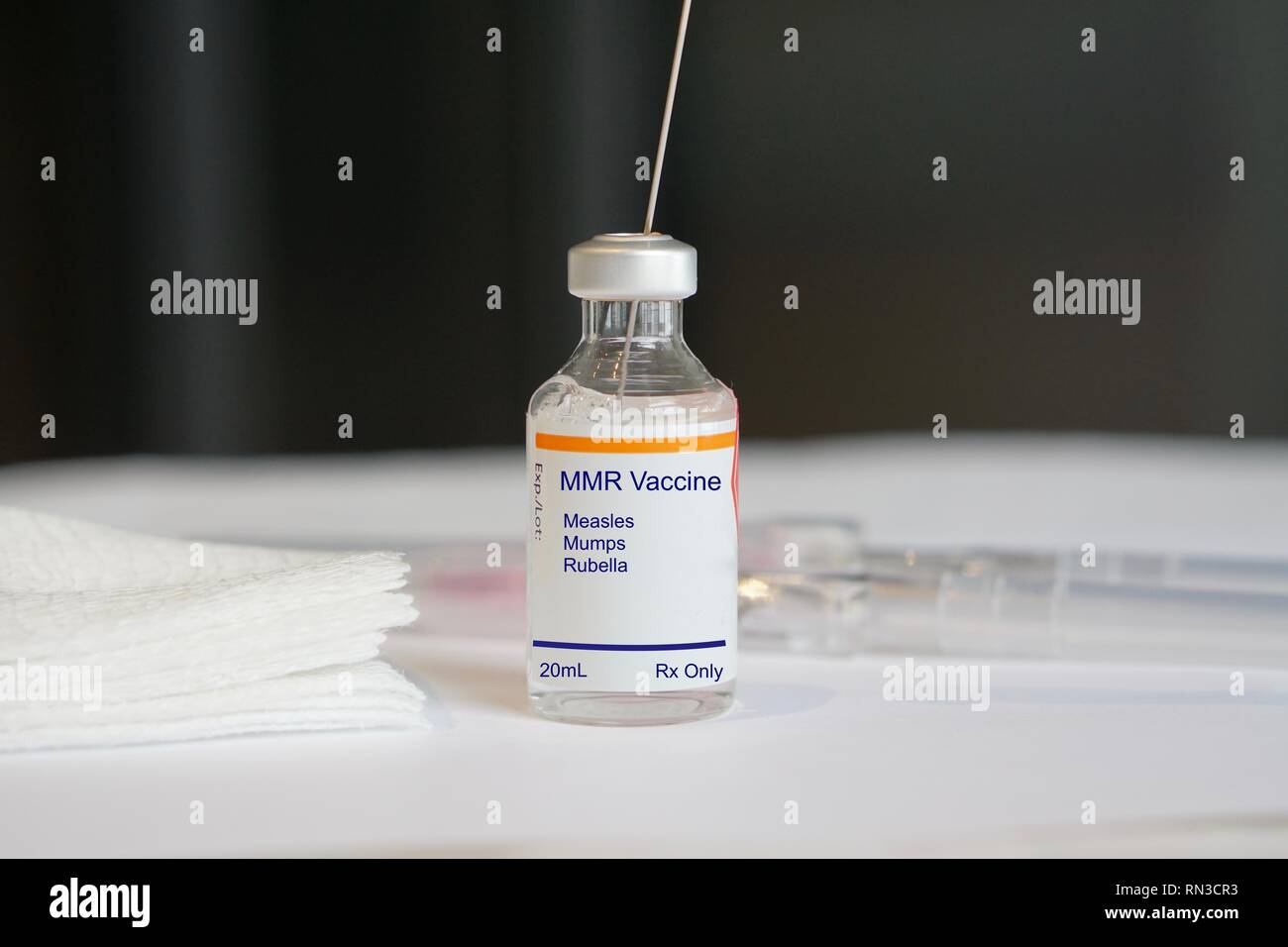 MMR Vaccine for measles, mumps, and rubella in a glass vial in a medical setting Stock Photo