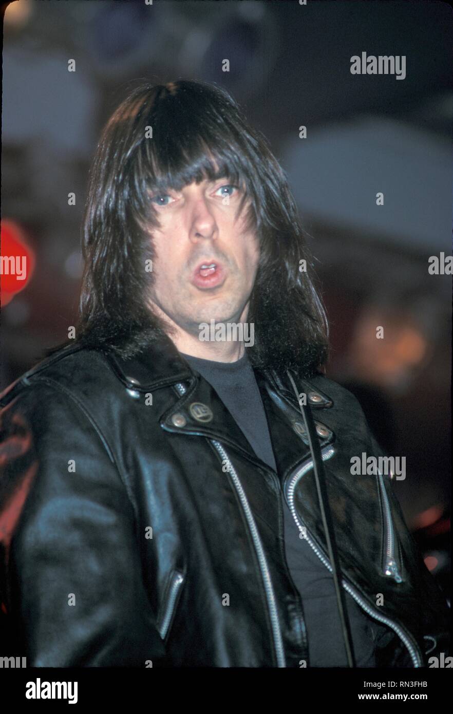 John Cummings better known by the stage name Johnny Ramone, guitarist of the punk rock band the Ramones is shown performing on stage during a 'live' concert appearance. Stock Photo